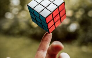 image of a rubik's cube balanced on a finger