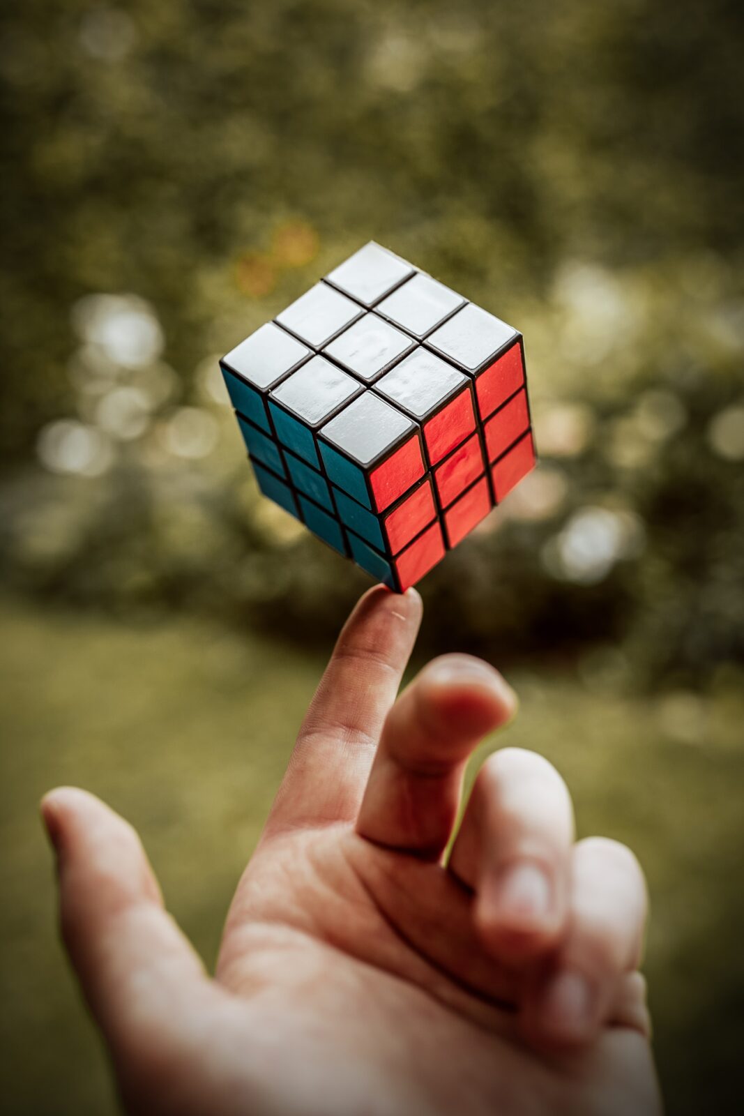 image of a rubik's cube balanced on a finger